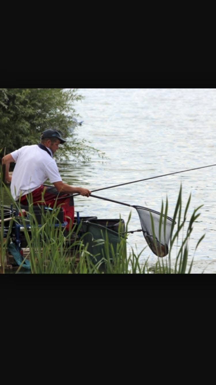 Dale Shepherd landing a fish with a net.
